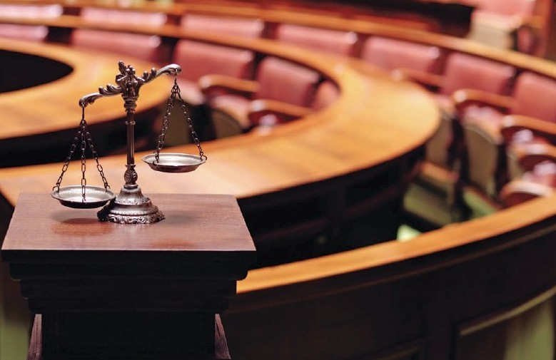 Inside a courtroom, scales of justice