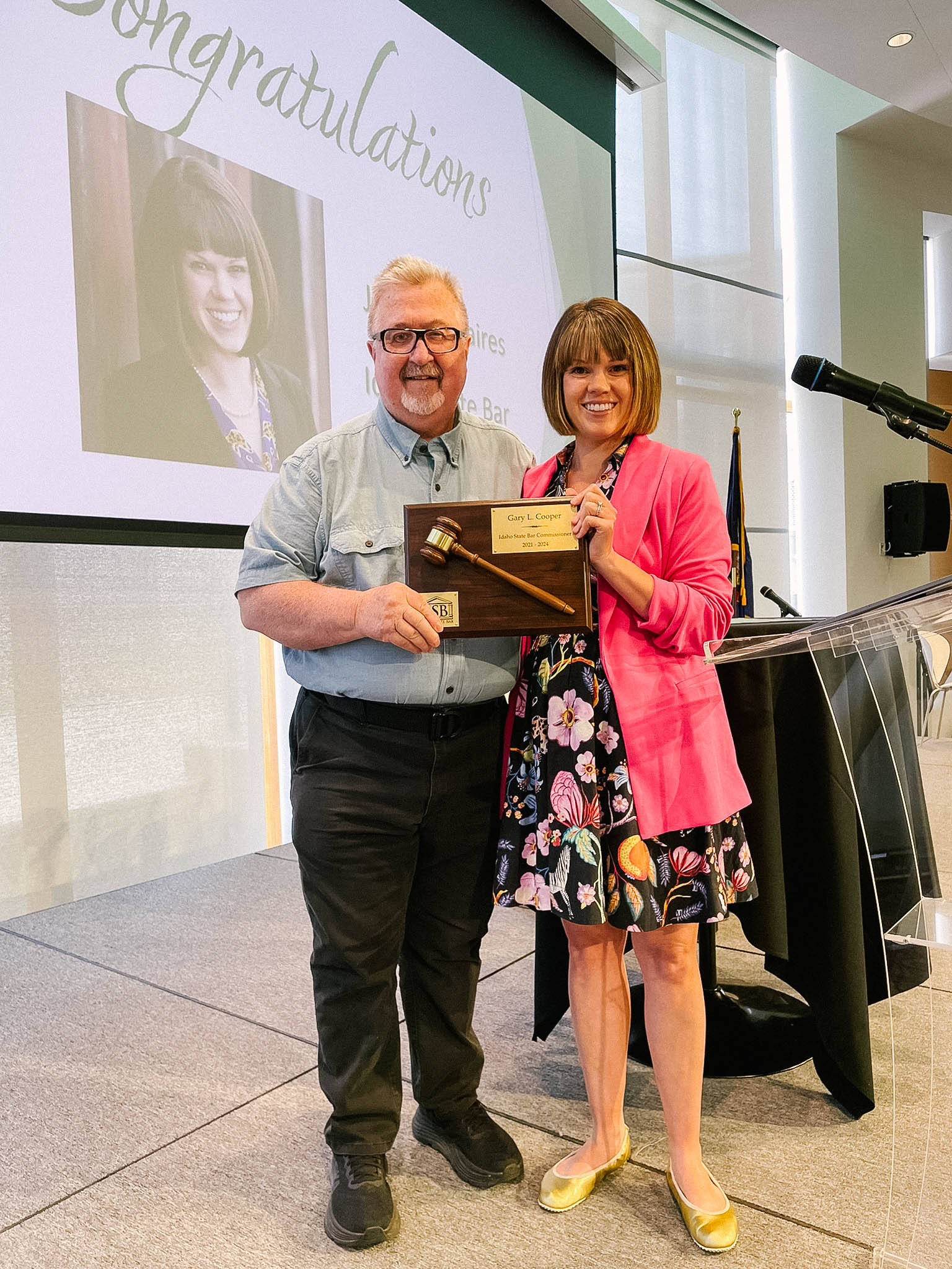 Gary Cooper passes the gavel to incoming president, Jillian Caires.