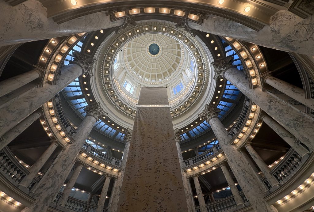 interior of the idaho capitol building's rotunda, with a replica of the declaration of independence hanging down