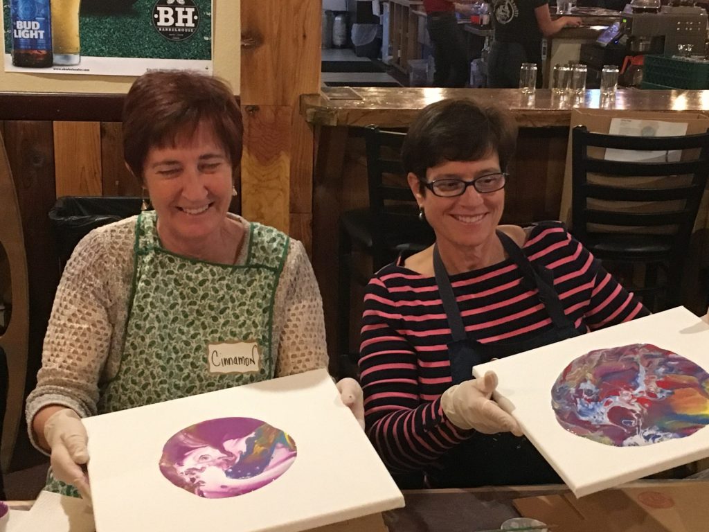 Candy Dale and Nancy Baskin Painting and in aprons