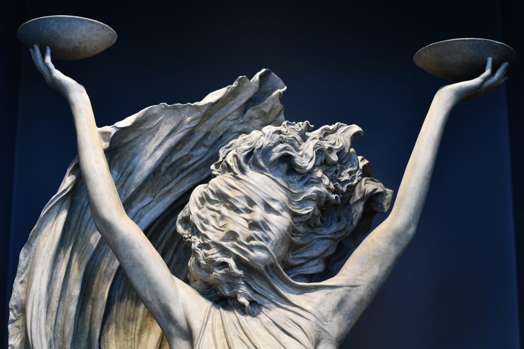 statue of women holding two bowls