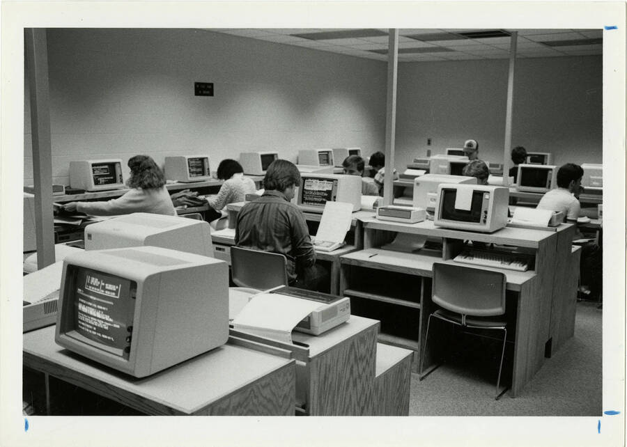 black and white image of students working in computer lab