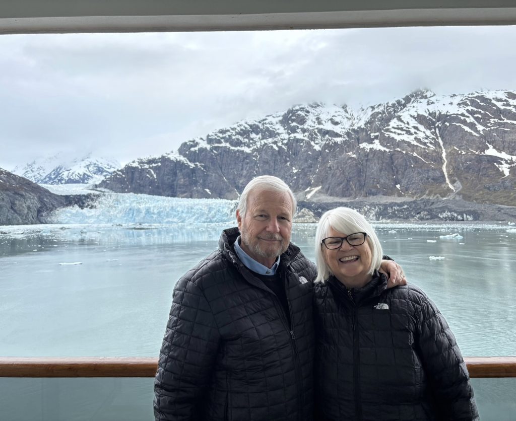 man and woman in front of glaciers and mountains