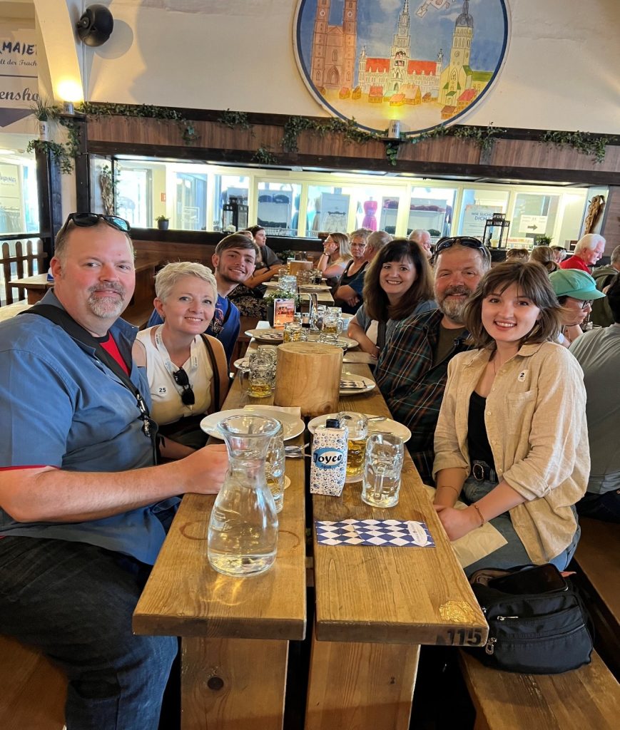 My son and I with some members of our bonus family—the Flemings—travelling in Europe for
my son’s high school graduation in 2024. This photo was taken at a Hofbräu Wirtshaus in Berlin,
Germany. Pictured: Todd Fleming; Judge Lorello; Spencer Lorello; Lori Fleming; Ted Fleming; Emily
Fleming (and background diners I have never met). Not pictured but deeply missed: Tim Fleming.