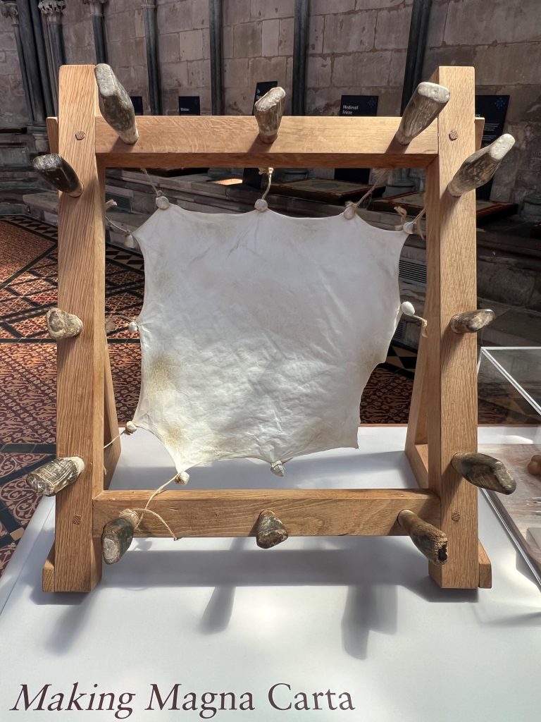 Photograph of display at Salisbury Cathedral in Salisbury, United Kingdom, depicting a piece of stretched and dried parchment made of sheepskin similar to that used to write Magna Carta.