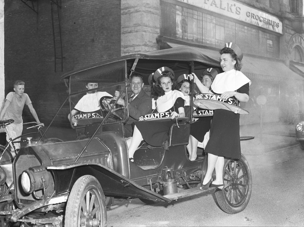 women in car with "stamps" trays