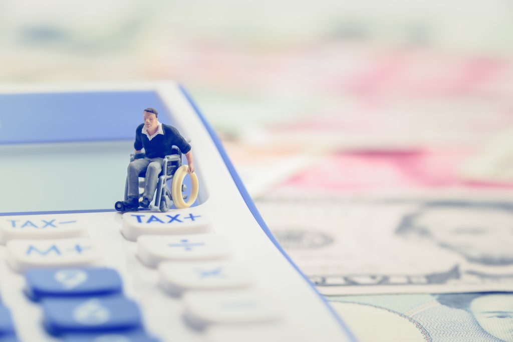 figurine of man in wheelchair on forms