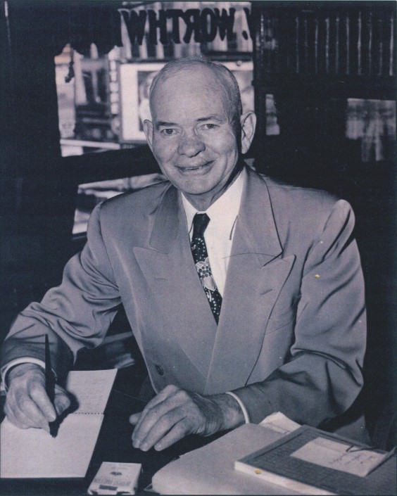 black and white image of man at desk