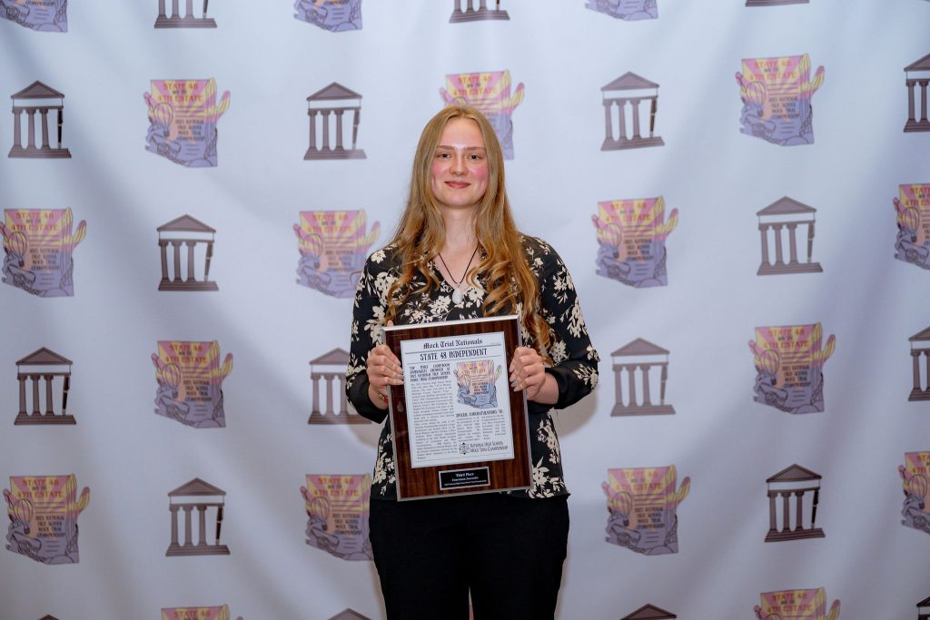 image of nora lafferty holding her 3rd place journalist entry